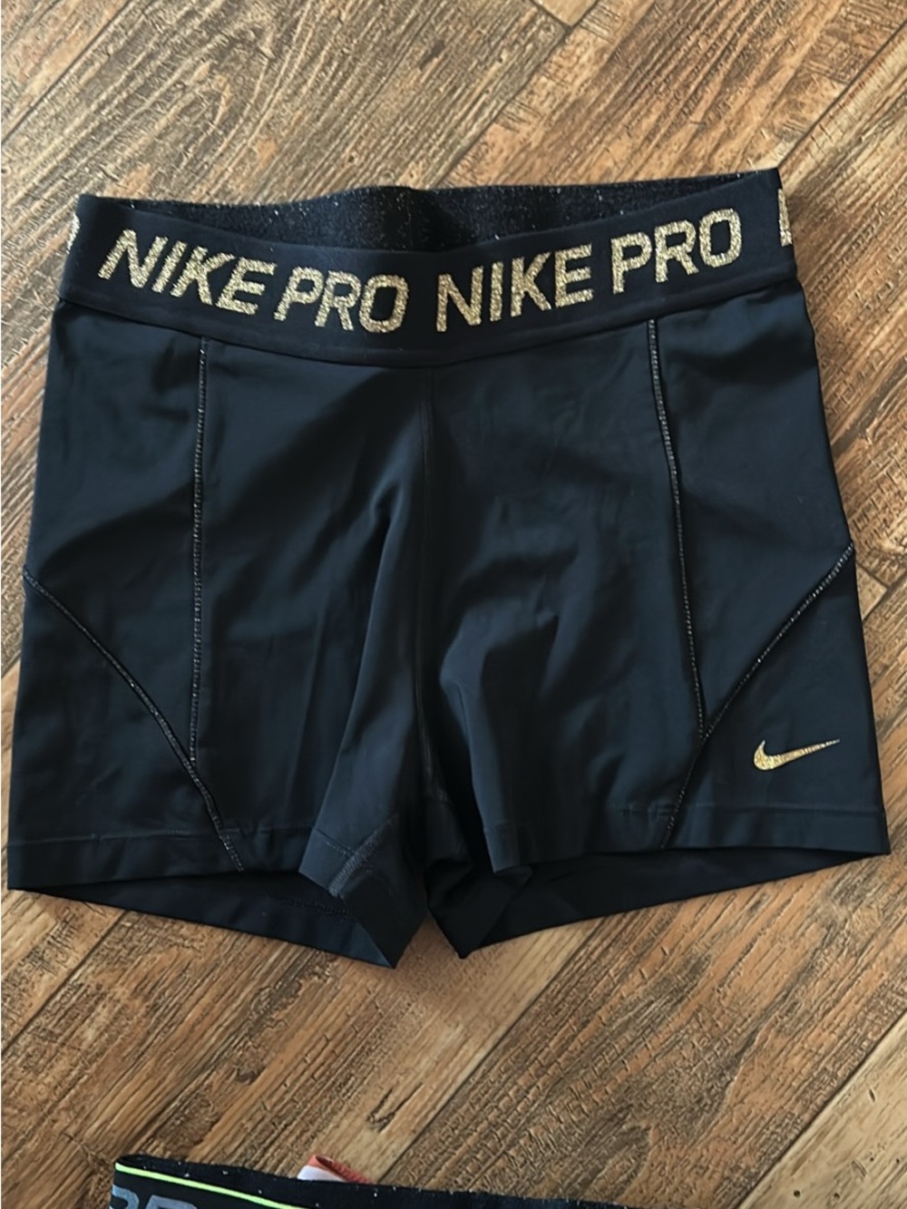 Women's Black Nike Pro Bike Shorts with Gold Logo and accents